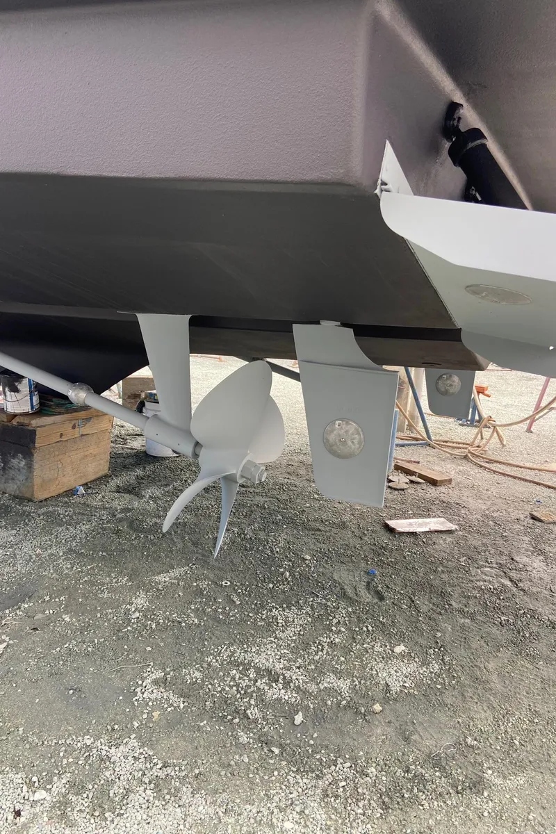 Slide: The Image of 1999 Silverton 453 Motor Yacht propeller and rudder detail on dry dock. - 13