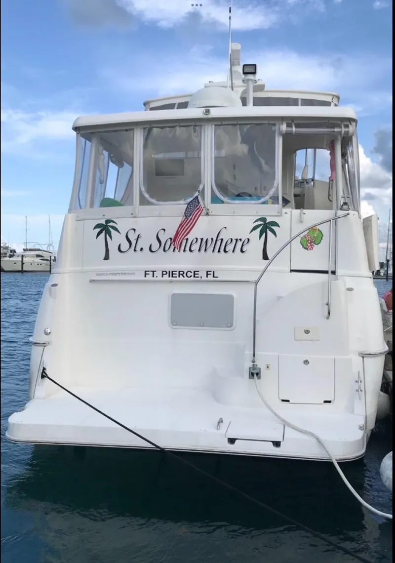 Slide: The Image of 1999 Silverton 453 Motor Yacht docked, featuring "St. Somewhere" name and palm tree graphics. - 15