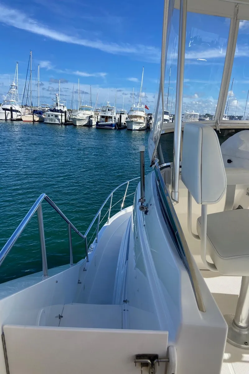 Slide: The Image of 1999 Silverton 453 Motor Yacht docked at marina with clear blue sky. - 17