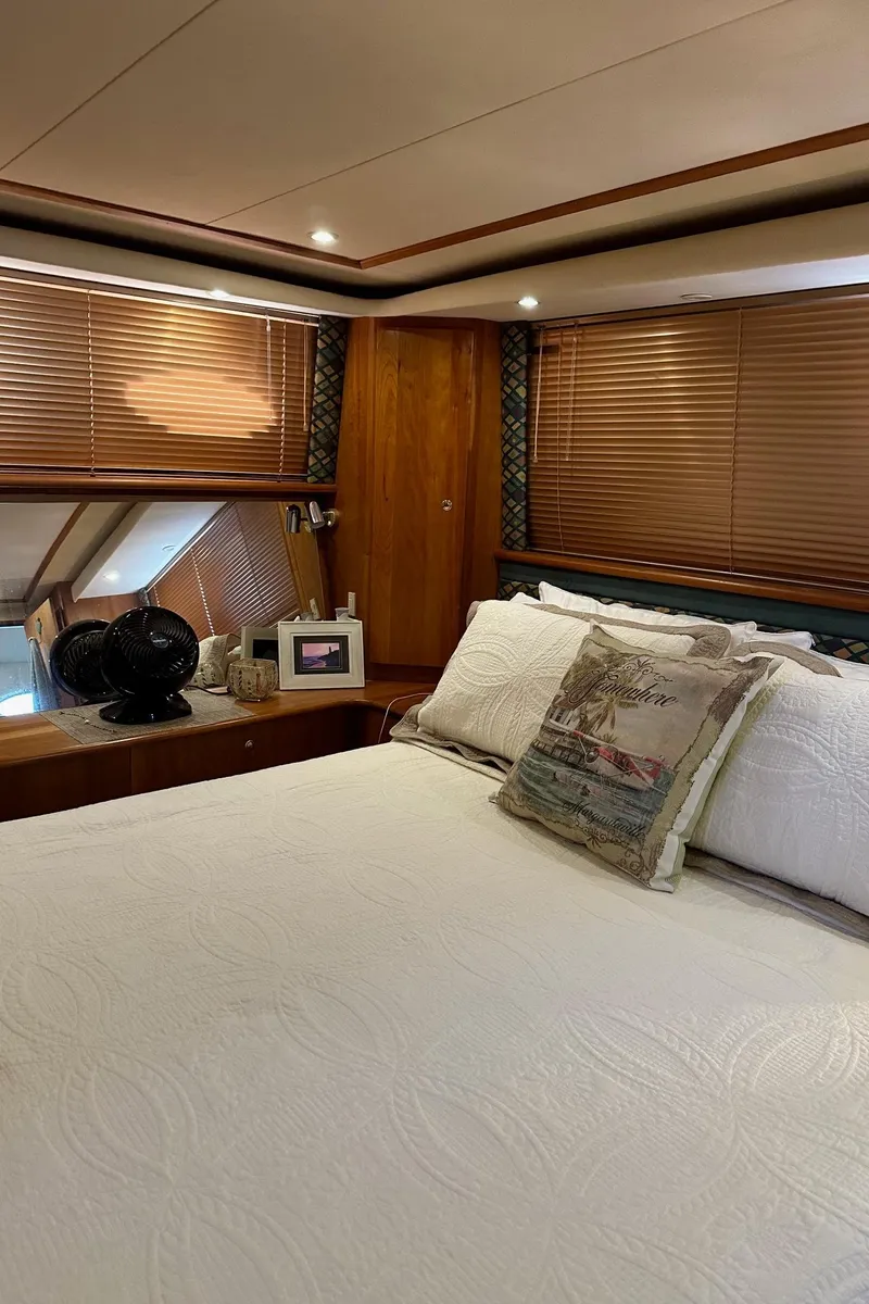 Slide: The Image of 1999 Silverton 453 Motor Yacht bedroom with cozy decor and wooden blinds. - 20