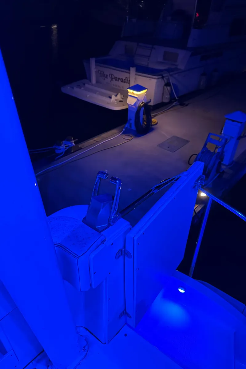 Slide: The Image of 1999 Silverton 453 Motor Yacht docked at night with blue ambient lighting. - 22