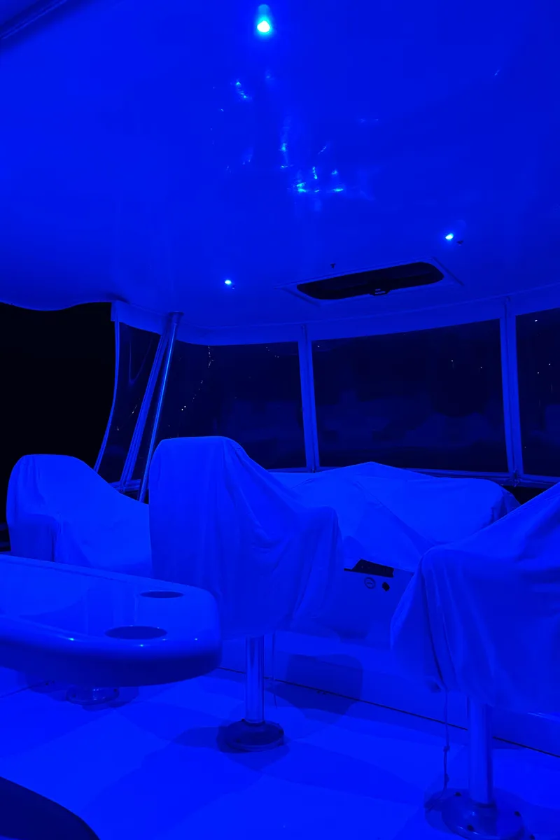 Slide: The Image of 1999 Silverton 453 Motor Yacht interior with blue ambient lighting. - 24