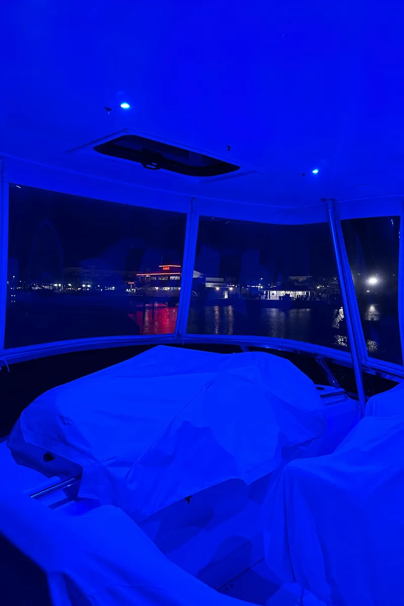 Slide: The Image of 1999 Silverton 453 Motor Yacht interior with blue lighting at night. - 28