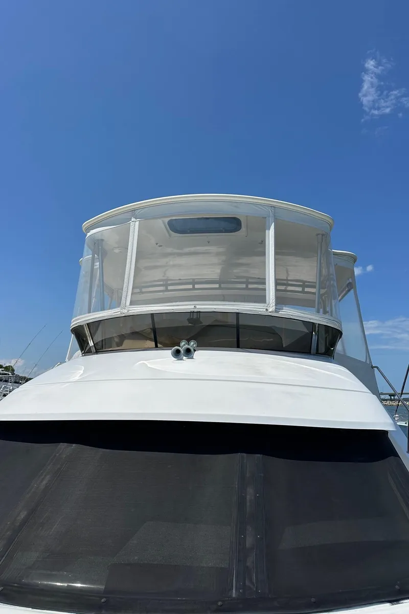 Slide: The Image of 1999 Silverton 453 Motor Yacht against clear blue sky. - 30