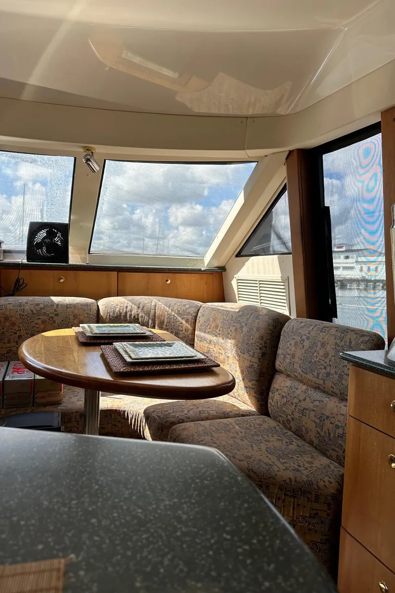Slide: The Image of Interior of 1999 Silverton 453 Motor Yacht with plush seating and panoramic windows. - 33
