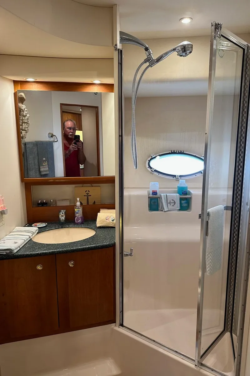 Slide: The Image of 1999 Silverton 453 Motor Yacht bathroom with shower and vanity. - 34