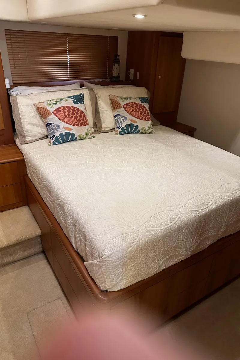 Slide: The Image of Cozy bedroom in 1999 Silverton 453 Motor Yacht with decorative pillows and wooden accents. - 36