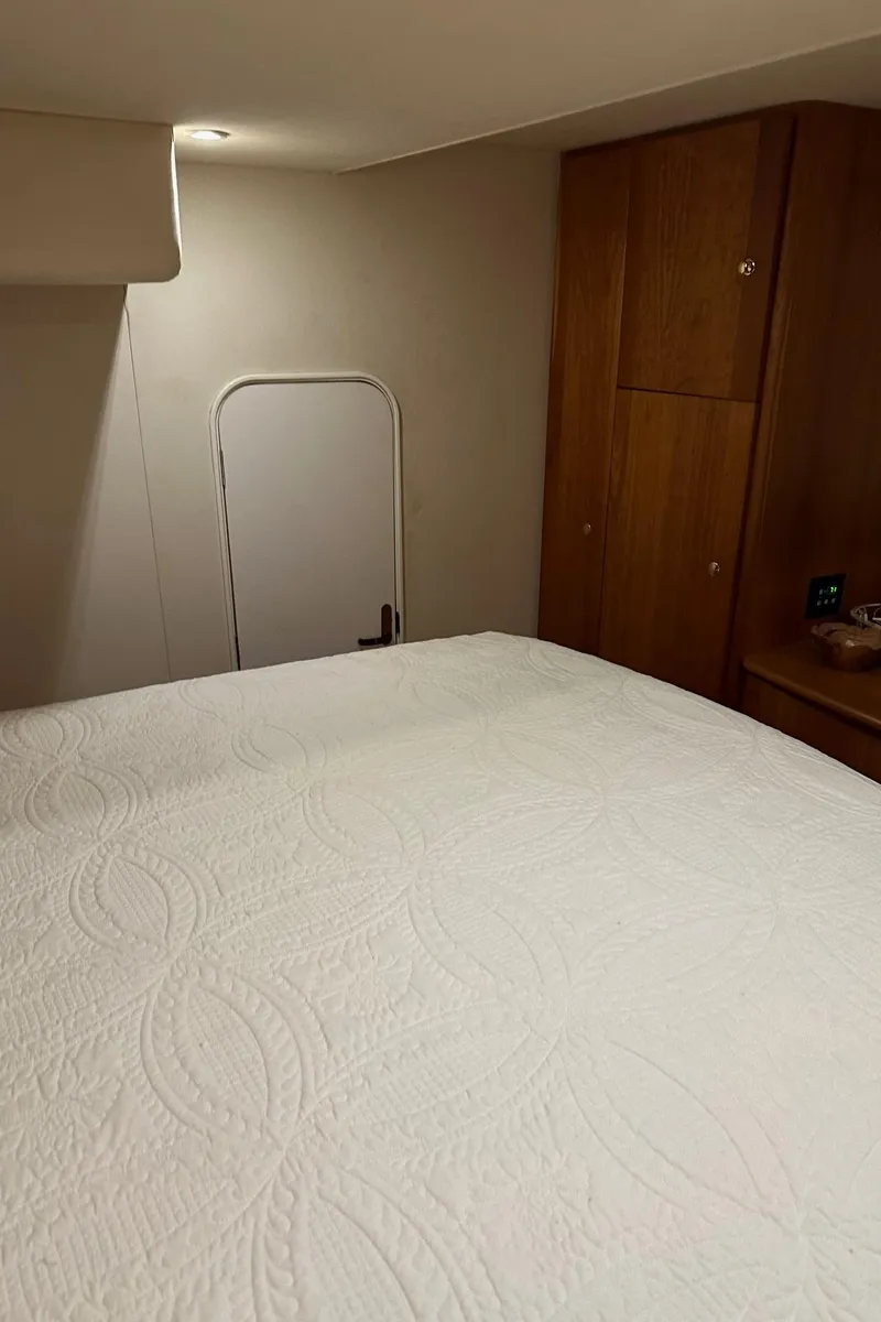 Slide: The Image of Interior cabin of 1999 Silverton 453 Motor Yacht with bed and wooden cabinets. - 38