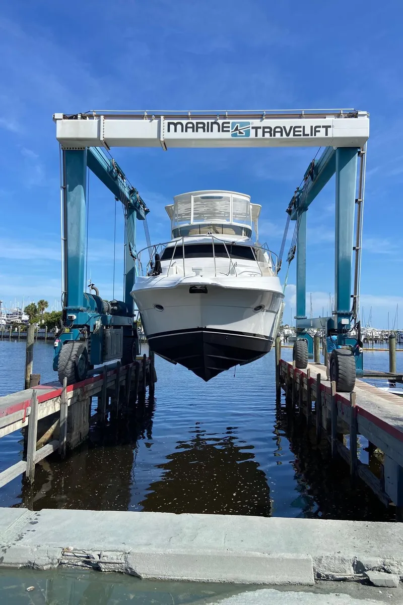 Slide: The Image of 1999 Silverton 453 Motor Yacht lifted by Marine Travelift at a marina. - 4