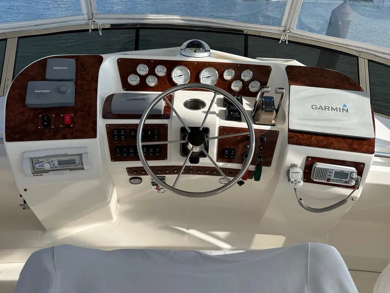 Slide: The Image of 1999 Silverton 453 Motor Yacht helm with Garmin navigation and classic wood accents. - 44