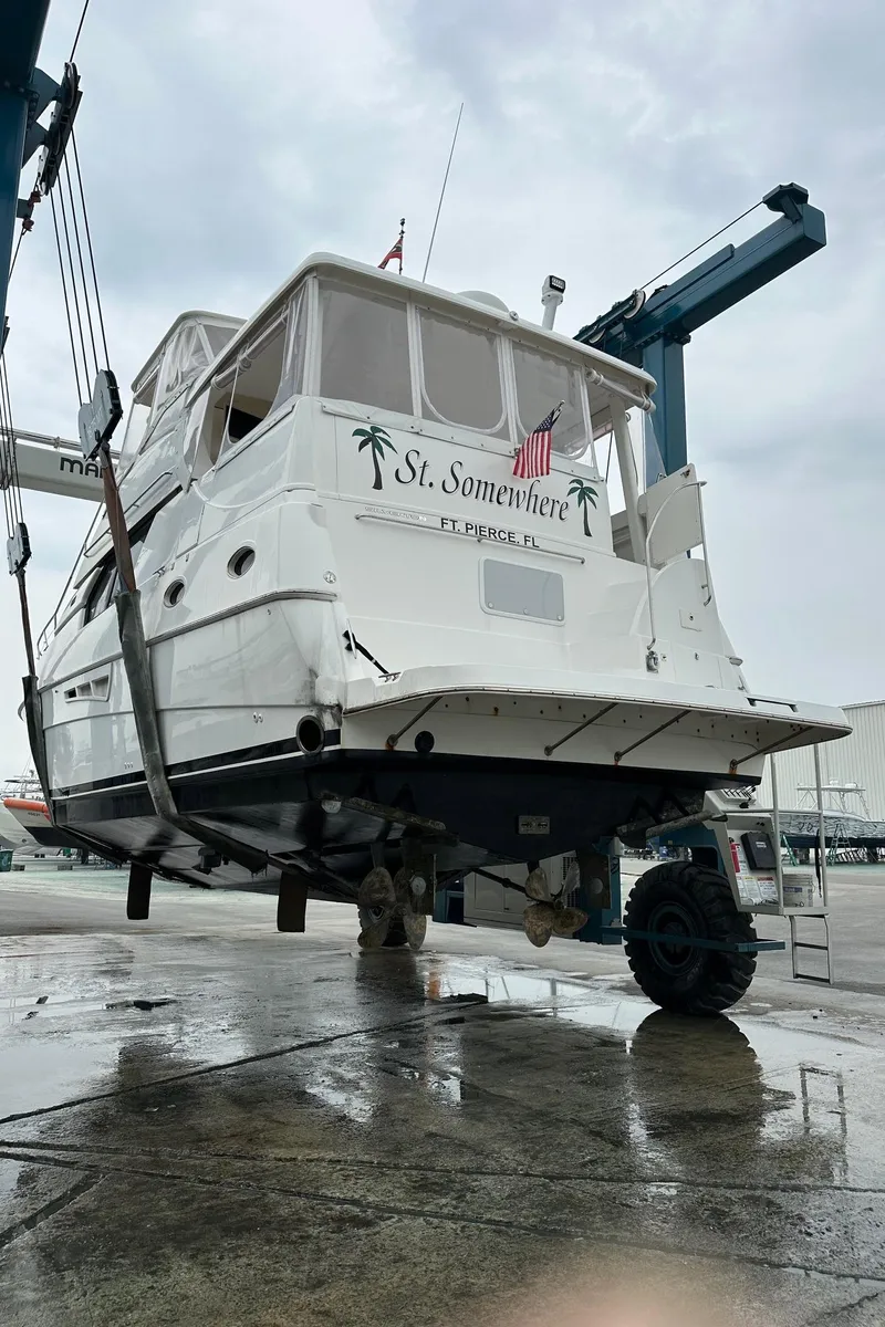 Slide: The Image of 1999 Silverton 453 Motor Yacht on lift at marina, overcast sky. - 5