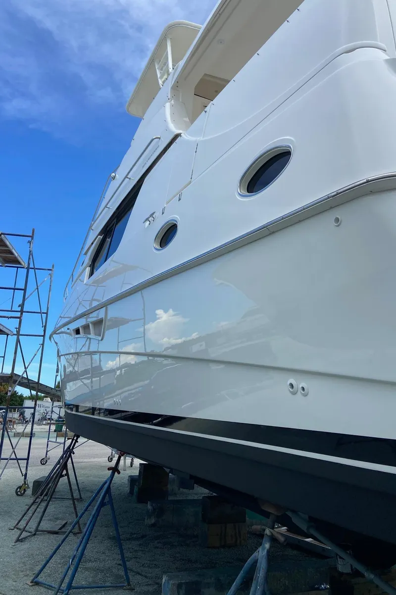 Slide: The Image of 1999 Silverton 453 Motor Yacht on dry dock with clear blue sky background. - 6