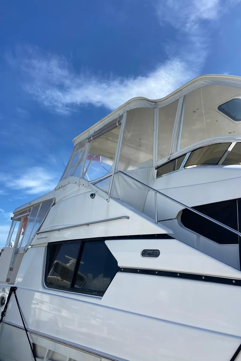 Slide: The Image of 1999 Silverton 453 Motor Yacht against a clear blue sky. - 8
