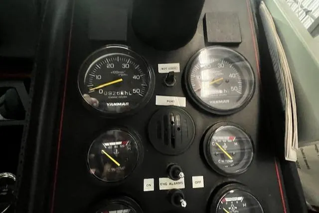Slide: The Image of Dashboard of a 1985 Bayliner 3870 Motoryacht with Flybridge, featuring Yanmar gauges. - 10
