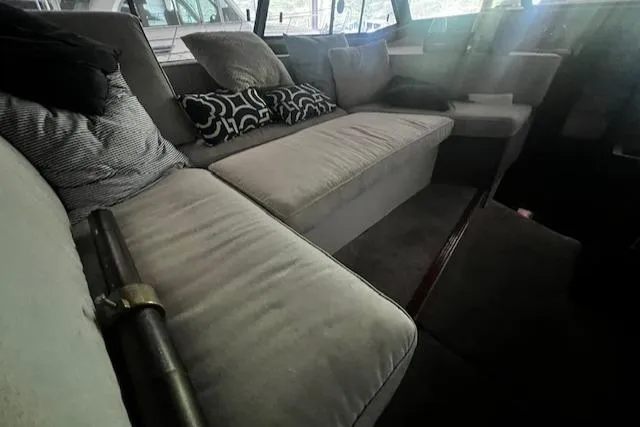 Slide: The Image of Interior of 1985 Bayliner 3870 Motoryacht with comfortable seating and decorative pillows. - 12