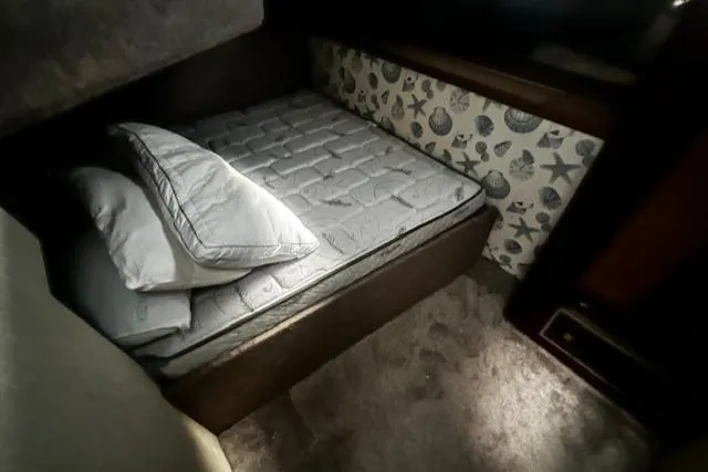 Slide: The Image of Cozy cabin bed in 1985 Bayliner 3870 Motoryacht with pillows and patterned wall. - 15