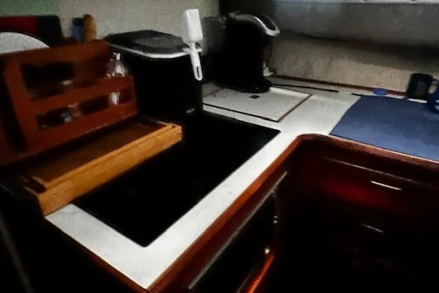 Slide: The Image of 1985 Bayliner 3870 Motoryacht kitchen with modern appliances and wooden cabinetry. - 19