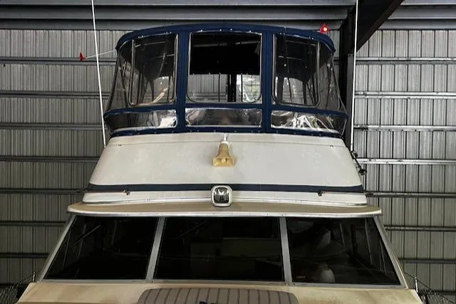 Slide: The Image of 1985 Bayliner 3870 Motoryacht with Flybridge in storage, front view. - 25