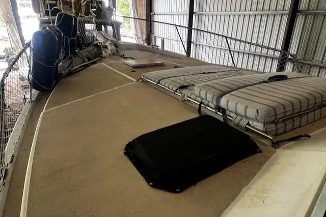 Slide: The Image of 1985 Bayliner 3870 Motoryacht deck with cushions and railing in storage. - 26