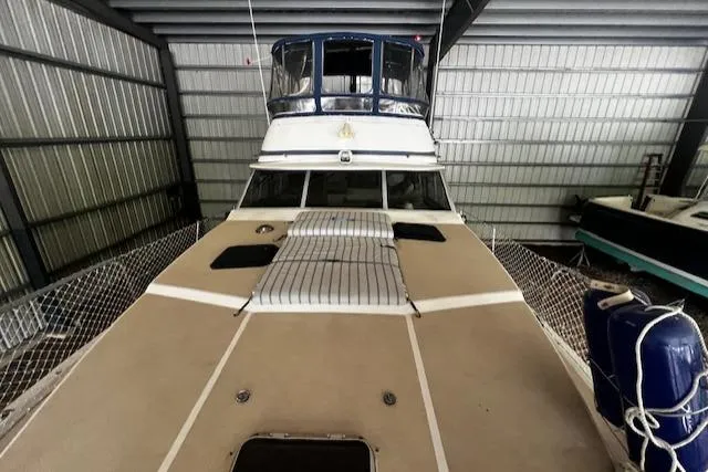 Slide: The Image of 1985 Bayliner 3870 Motoryacht with Flybridge in storage, showcasing deck and flybridge. - 27
