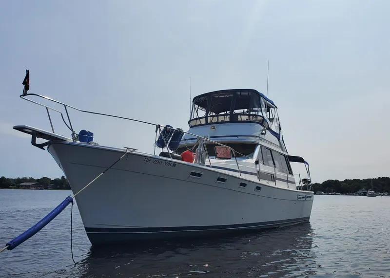 Slide: The Image of 1985 Bayliner 3870 Motoryacht with Flybridge on calm water, side view. - 40