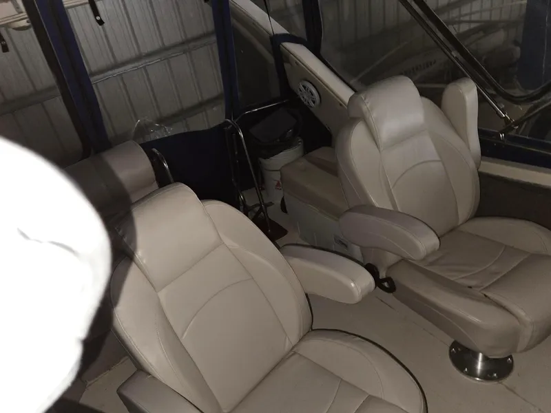 Slide: The Image of Interior of 1985 Bayliner 3870 Motoryacht with Flybridge, featuring two beige captain's chairs. - 6