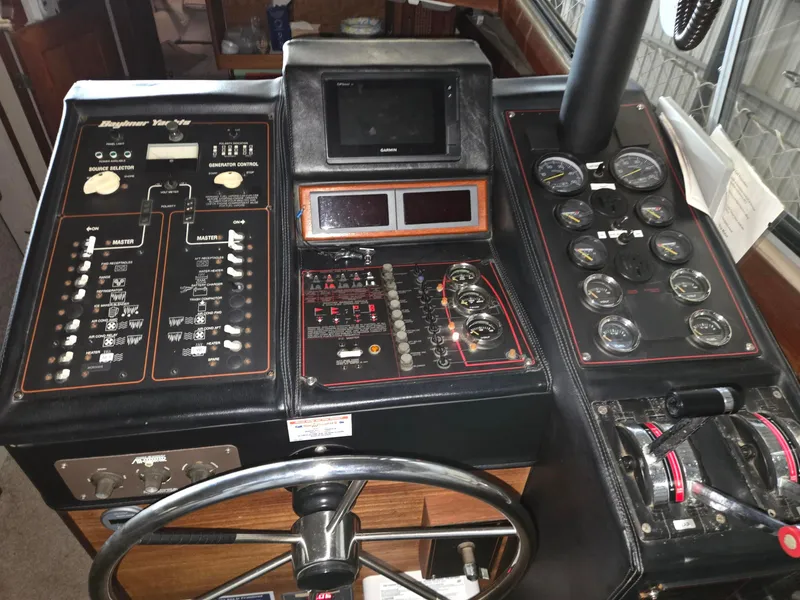 Slide: The Image of Control panel of a 1985 Bayliner 3870 Motoryacht with Flybridge, featuring gauges and steering wheel. - 7