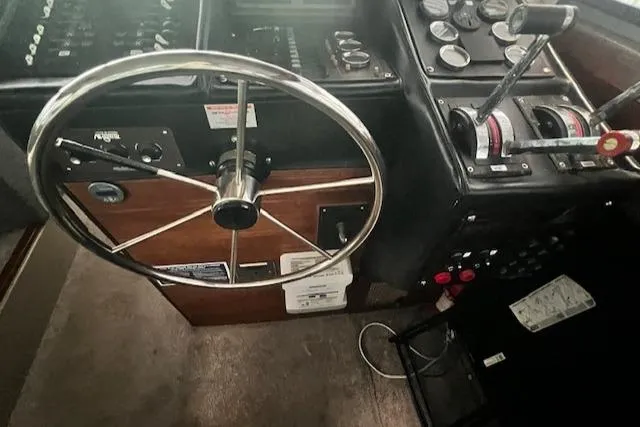 Slide: The Image of 1985 Bayliner 3870 Motoryacht helm with steering wheel and control panel. - 8