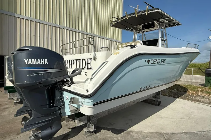 Slide: The Image of 2006 Century 3200 Center Console boat with Yamaha engine, docked outdoors. - 0