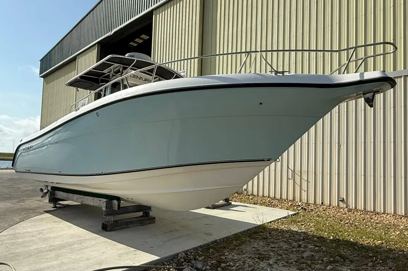 Slide: The Image of 2006 Century 3200 Center Console boat on dry dock near a large warehouse. - 1