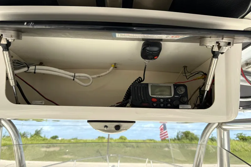 Slide: The Image of 2006 Century 3200 Center Console boat's electronic compartment with radio and wiring. - 10