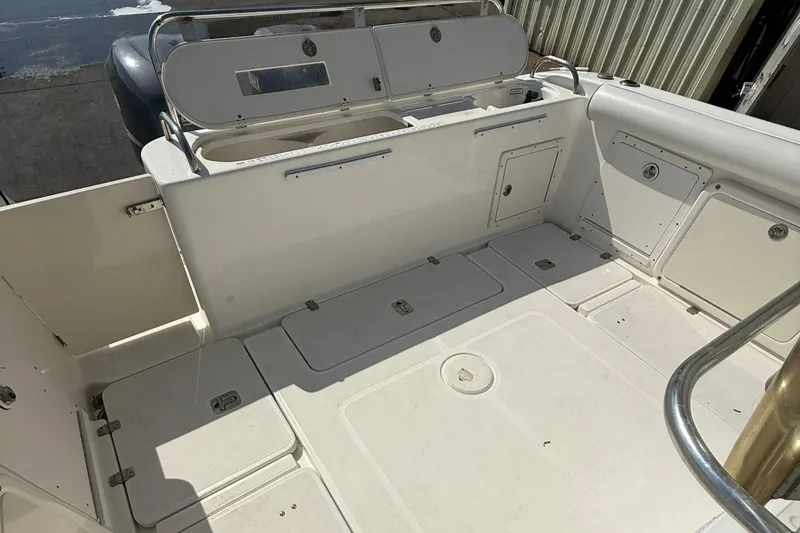 Slide: The Image of 2006 Century 3200 Center Console boat interior with storage compartments and seating area. - 15