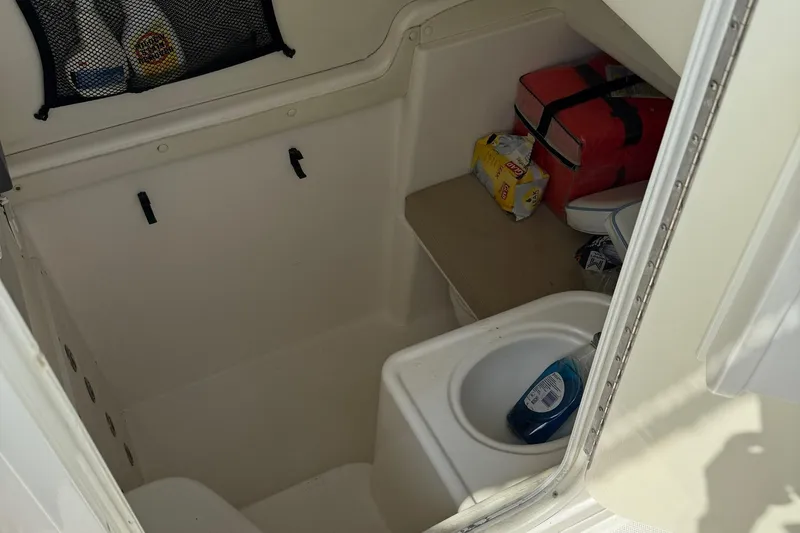 Slide: The Image of 2006 Century 3200 Center Console boat interior with storage and sink. - 19