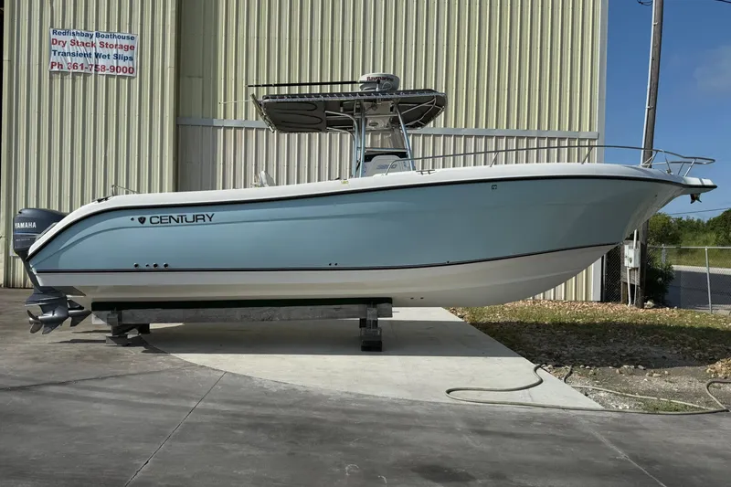 Slide: The Image of 2006 Century 3200 Center Console boat with Yamaha engines, parked outdoors. - 2