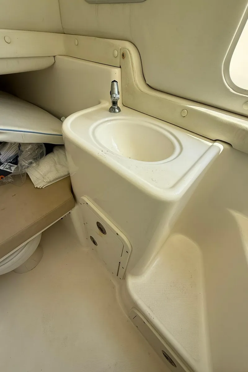 Slide: The Image of 2006 Century 3200 Center Console boat interior with sink and storage area. - 20