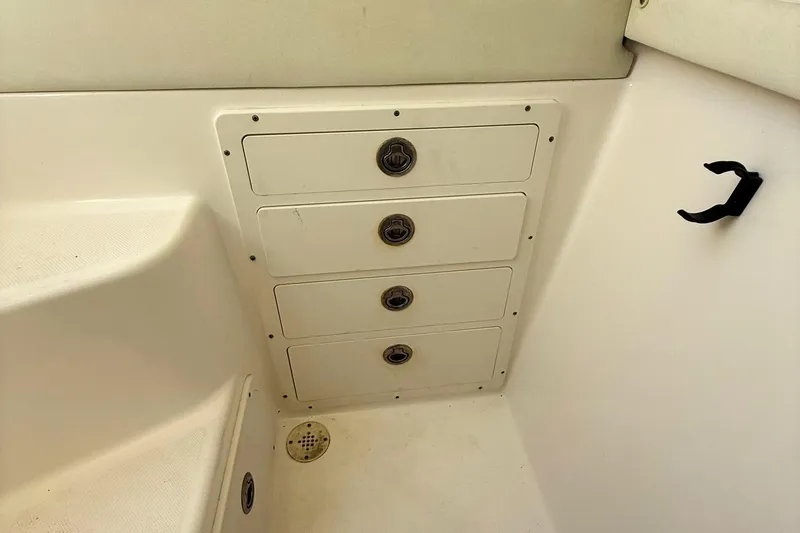 Slide: The Image of 2006 Century 3200 Center Console boat interior with storage drawers and drain. - 21