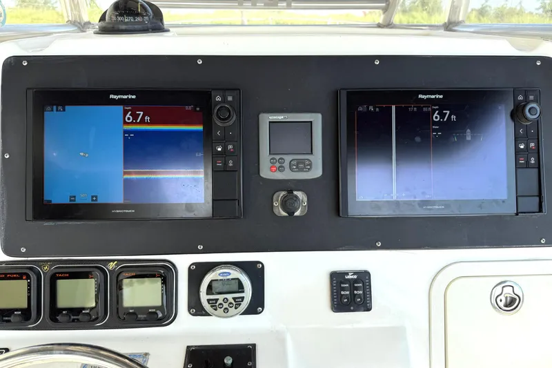 Slide: The Image of Control panel of a 2006 Century 3200 Center Console boat with navigation screens. - 7