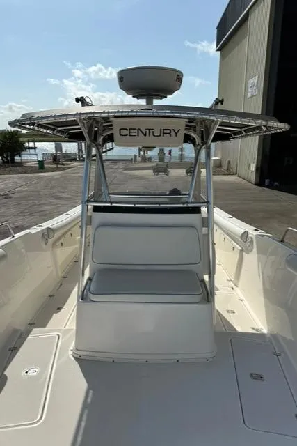 Slide: The Image of 2006 Century 3200 Center Console boat docked near a waterfront building. - 8