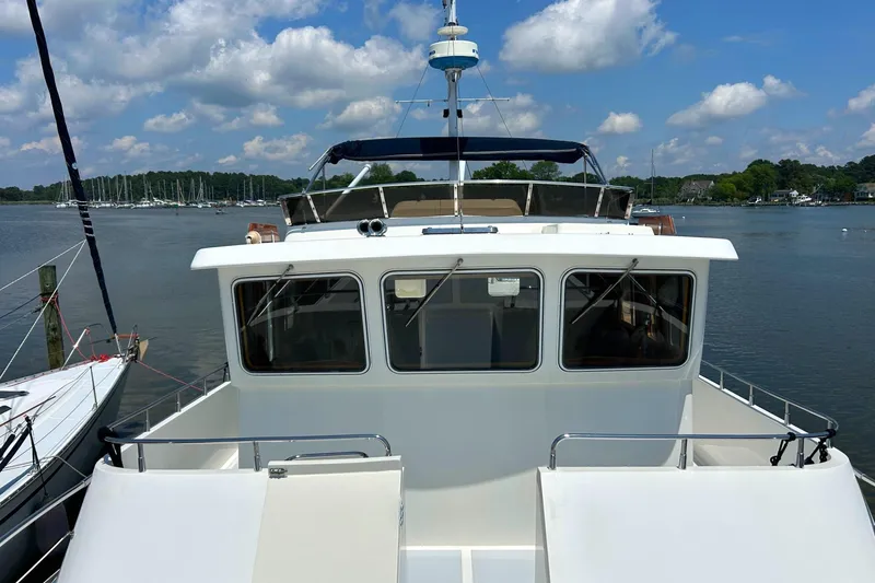 Slide: The Image of Selene 43 yacht from 1999 on a calm lake under a partly cloudy sky. - 10