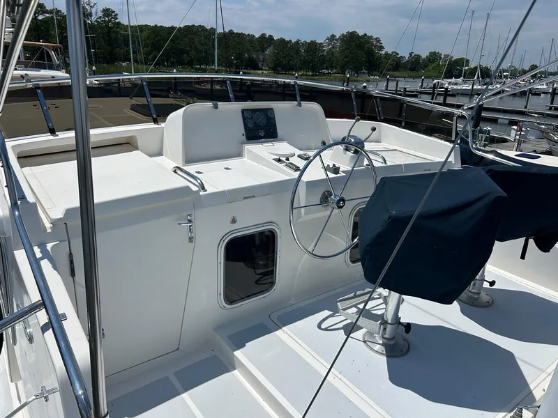 Slide: The Image of Cockpit of 1999 Selene 43 yacht with steering wheel and covered seats. - 12