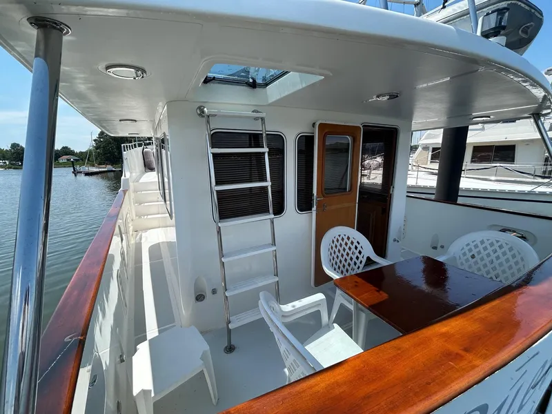 Slide: The Image of Selene 43 yacht deck with seating, table, and ladder, 1999 model. - 13