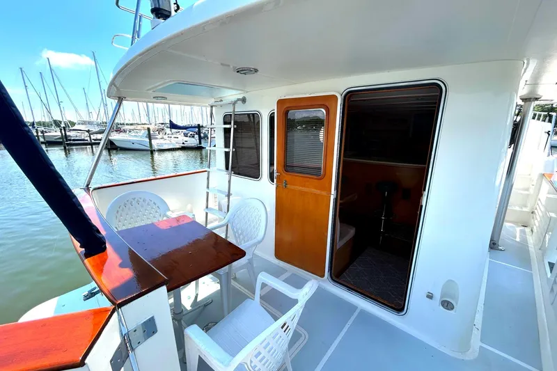 Slide: The Image of Selene 43 yacht deck, 1999 model, featuring seating area and marina view. - 15