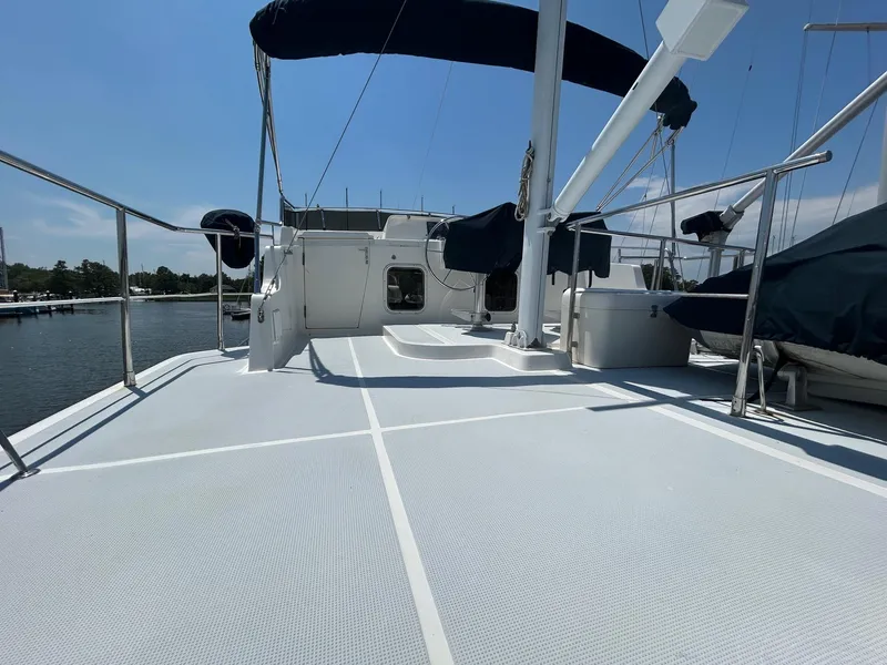Slide: The Image of Selene 43 yacht deck, 1999 model, with blue canopy, docked by the water. - 16