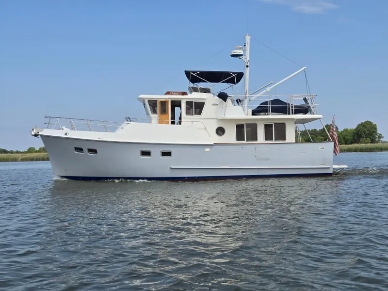 Slide: The Image of Selene 43 yacht from 1999 cruising on calm waters under a clear blue sky. - 2