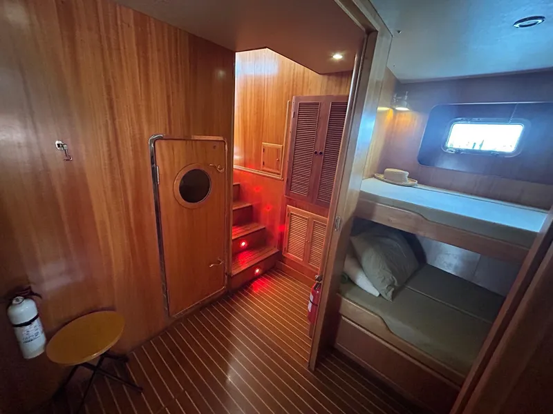 Slide: The Image of Cozy wooden interior of 1999 Selene 43 yacht with bunk beds and ambient lighting. - 28