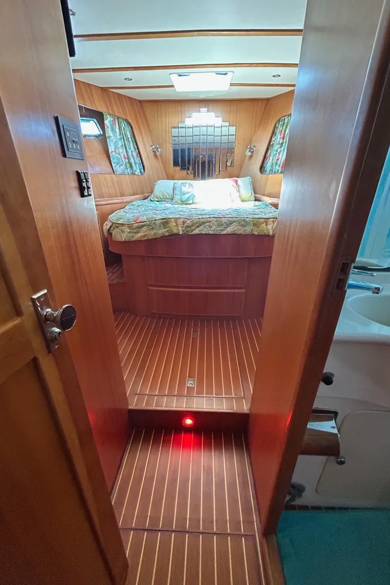 Slide: The Image of Cozy cabin interior of 1999 Selene 43 yacht with wood paneling and bed. - 29
