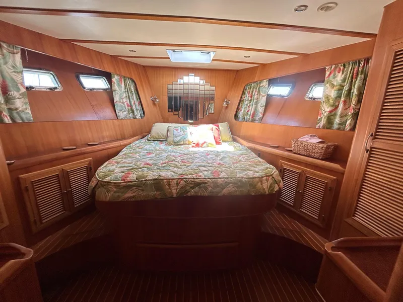 Slide: The Image of Luxurious cabin interior of a 1999 Selene 43 yacht with cozy bedding and wooden finishes. - 32