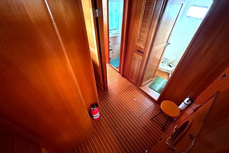 Slide: The Image of Interior of 1999 Selene 43 yacht, featuring wooden flooring and a compact bathroom. - 40