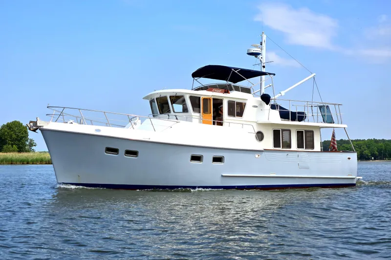 Slide: The Image of Selene 43 yacht from 1999 cruising on a calm waterway under a clear blue sky. - 5