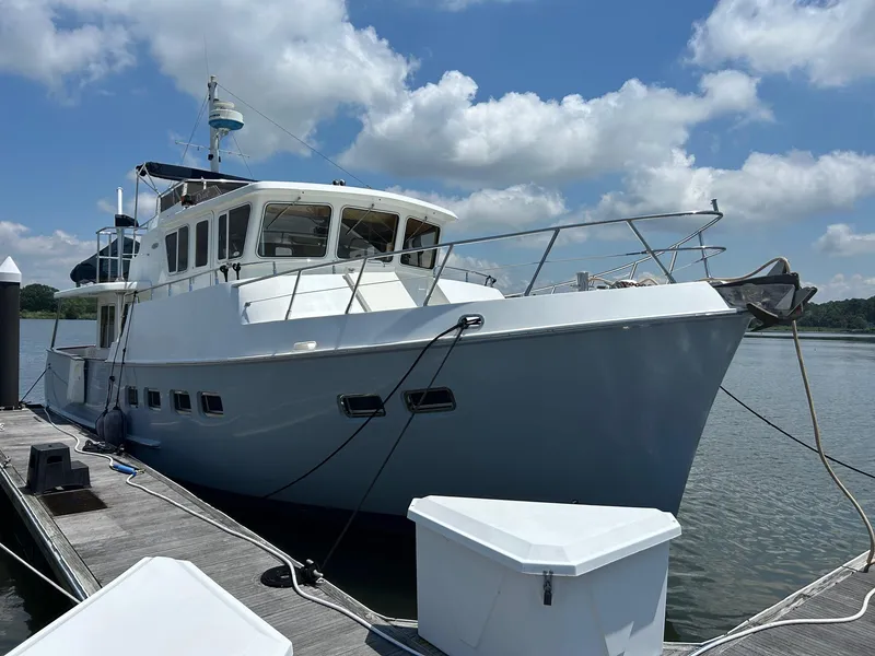 Slide: The Image of Selene 43 yacht from 1999 docked under a blue sky with clouds. - 6